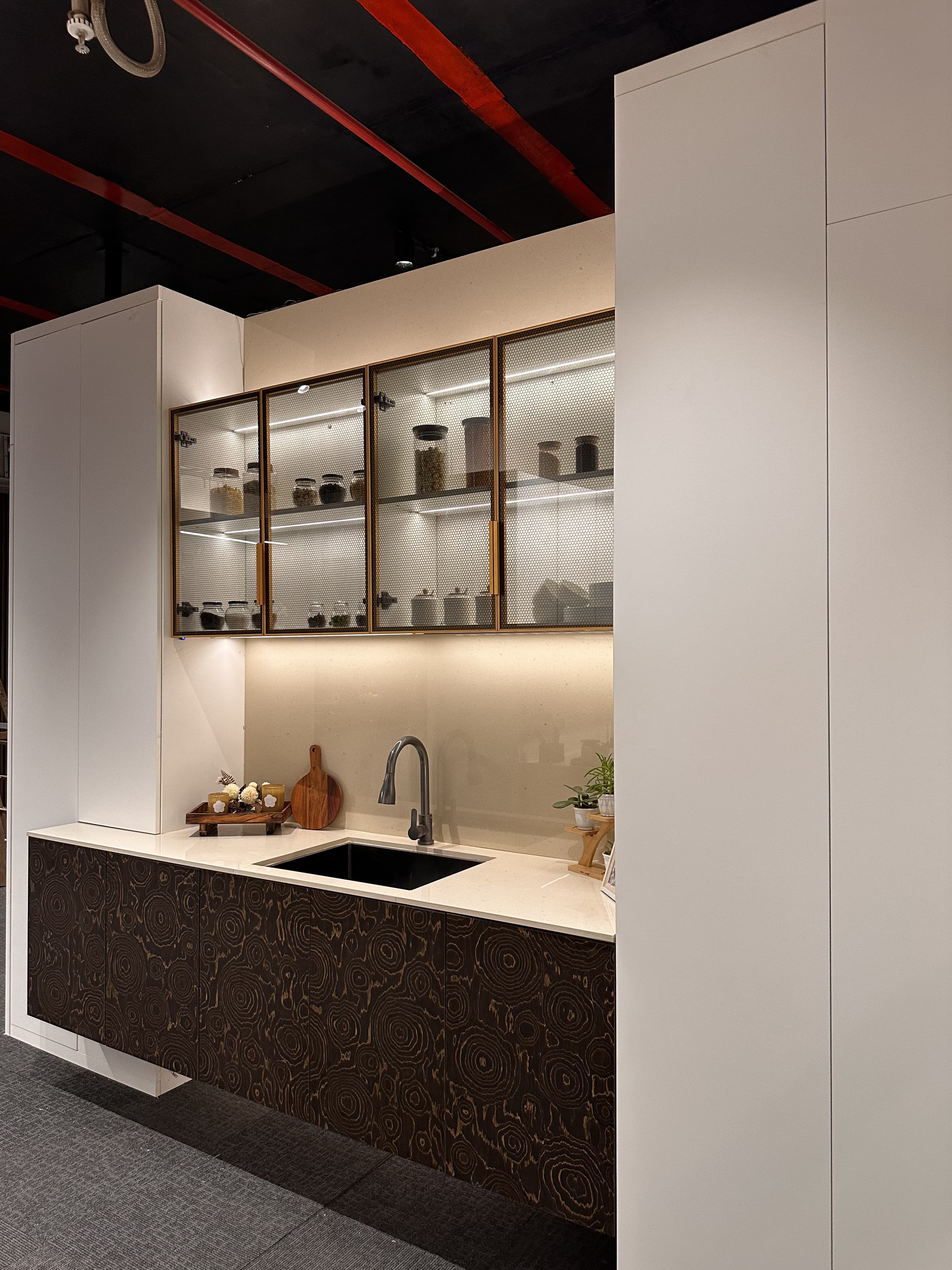 Light utility kitchen with glass-fronted upper cabinets